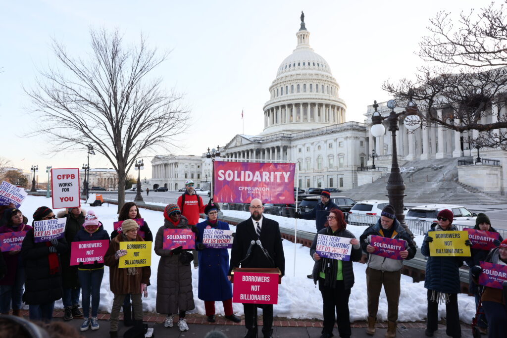 Borrowers Not Billionaires - Rally To Defend CFPB -On February 09, 2026 in Washington, DC. (Photo by Jemal Countess/Getty Images for Protect Borrowers) - signs read "Borrowers Not Billionaires" "CFPB Works For You" "Solidarity" and more